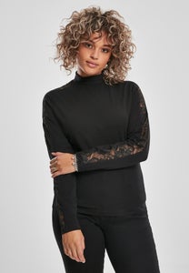 Musta paita korkealla kauluksella ja pitsiyksityiskohdilla